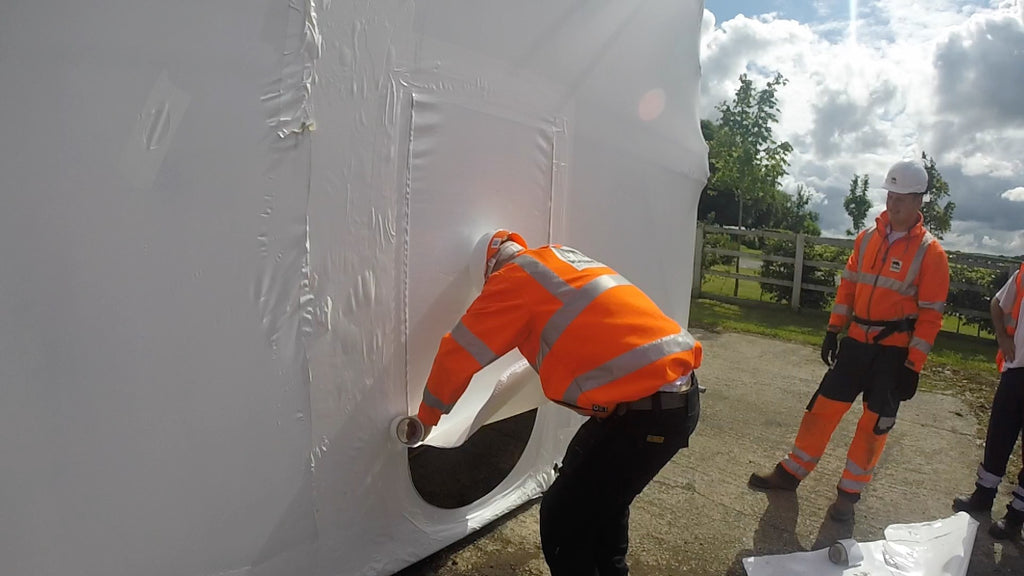 zipped access door being installed in shrink wrap - outside view